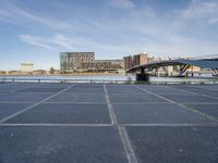 there is a large parking lot by the water and buildings at the waterfront park in downtown boston