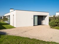 this is a home that has an open garage and two houses on the left side