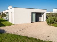 this is a home that has an open garage and two houses on the left side