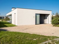 this is a home that has an open garage and two houses on the left side