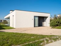 this is a home that has an open garage and two houses on the left side