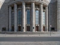 an entrance of a building with large columns and doors that spell out the word voltege