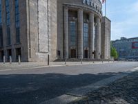 an entrance of a building with large columns and doors that spell out the word voltege