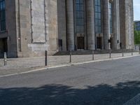 an entrance of a building with large columns and doors that spell out the word voltege