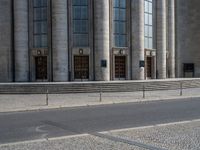 an entrance of a building with large columns and doors that spell out the word voltege