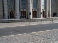 an entrance of a building with large columns and doors that spell out the word voltege