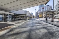 people walk down a walkway in downtown toronto, ontario, canada on a bright sunny day