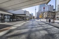 people walk down a walkway in downtown toronto, ontario, canada on a bright sunny day