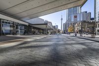 people walk down a walkway in downtown toronto, ontario, canada on a bright sunny day