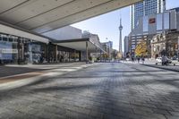 people walk down a walkway in downtown toronto, ontario, canada on a bright sunny day