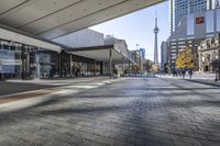 people walk down a walkway in downtown toronto, ontario, canada on a bright sunny day