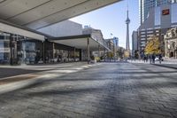 people walk down a walkway in downtown toronto, ontario, canada on a bright sunny day