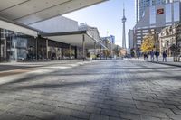 people walk down a walkway in downtown toronto, ontario, canada on a bright sunny day