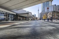 people walk down a walkway in downtown toronto, ontario, canada on a bright sunny day