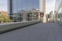 a walkway on top of a concrete block under construction with large skyscrapers in the background