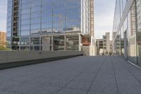 a walkway on top of a concrete block under construction with large skyscrapers in the background