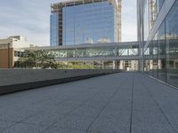 a walkway on top of a concrete block under construction with large skyscrapers in the background