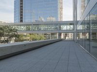 a walkway on top of a concrete block under construction with large skyscrapers in the background