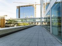 a walkway on top of a concrete block under construction with large skyscrapers in the background