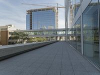 a walkway on top of a concrete block under construction with large skyscrapers in the background