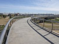 a walkway with two bikes going through it near the water and a dock on a pier