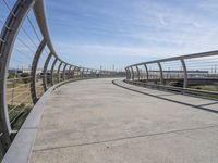 a walkway with two bikes going through it near the water and a dock on a pier