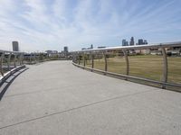 a walkway with two bikes going through it near the water and a dock on a pier