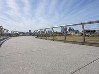 a walkway with two bikes going through it near the water and a dock on a pier