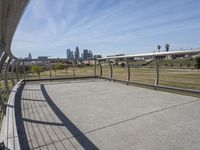 a walkway with two bikes going through it near the water and a dock on a pier