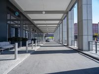 a walkway is shown next to a large building with windows on it's sides