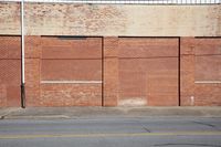 the large brick building is built into the side of a road to provide space for pedestrians and their traffic