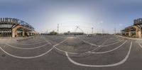 a fish eye lens shows the sun shining in a parking lot at a large city