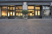 there is an image of a storefront and a planter on the sidewalk in front of it