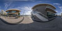 a fish eye lens photo of an architectural building on the waterfront with stairs and stairs