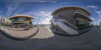 a fish eye lens photo of an architectural building on the waterfront with stairs and stairs