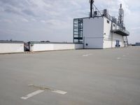 a boat is parked in an empty parking lot near an air port on the water