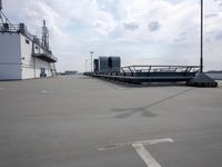 a boat is parked in an empty parking lot near an air port on the water