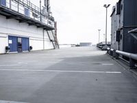 a boat is parked in an empty parking lot near an air port on the water