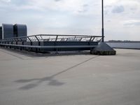 a boat is parked in an empty parking lot near an air port on the water