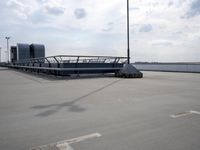 a boat is parked in an empty parking lot near an air port on the water