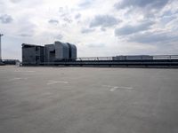 a boat is parked in an empty parking lot near an air port on the water