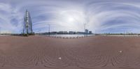 this is an image of a fish eye view of a brick walkway that runs along the waterfront