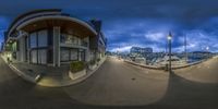 a fisheye image taken from outside a building with a large sailboat in the background