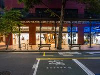 a city street has a store on one side and several people walking in the other