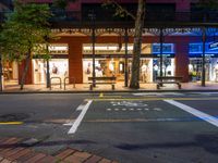 a city street has a store on one side and several people walking in the other