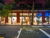 a city street has a store on one side and several people walking in the other