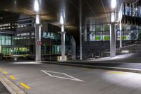 the empty empty roadway is painted yellow and has graffiti in it while parked cars are on the street