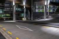 the empty empty roadway is painted yellow and has graffiti in it while parked cars are on the street