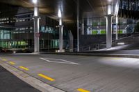 the empty empty roadway is painted yellow and has graffiti in it while parked cars are on the street