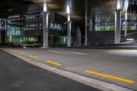 the empty empty roadway is painted yellow and has graffiti in it while parked cars are on the street